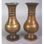 A PAIR OF 18TH CENTURY CHINESE BRONZE VASES, each supported on a high flared foot and with a