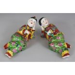 A PAIR OF CHINESE PORCELAIN FIGURES OF A RECLINING COUPLE, each holding an opium pipe, each base