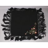 ANOTHER EARLY 20TH CENTURY CHINESE CANTON EMBROIDERED BLACK GROUND SILK SHAWL, decorated to one