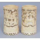 A GOOD PAIR OF 19TH CENTURY CHINESE CANTON IVORY BRUSHPOTS, the sides of each carved and pierced