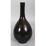 A 19TH CENTURY CHINESE MIRROR BLACK PORCELAIN BOTTLE VASE, the glaze thinning to brown at the rim,