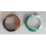 TWO CHINESE JADE-LIKE HARDSTONE RINGS. (2)