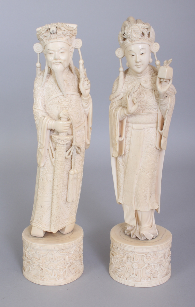 A GOOD PAIR OF EARLY 20TH CENTURY CHINESE IVORY FIGURES OF AN EMPEROR & AN EMPRESS, each standing on