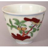 A CHINESE DOUCAI PORCELAIN CUP, decorated with two scenes of a bird perched on a leafy fruit bearing