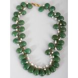 A GREEN HARDSTONE & SEED PEARL STYLE NECKLACE, the hardstone beads of teardrop form, approx. 32in
