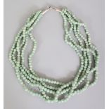 A CHINESE PALE GREEN JADE FIVE ROW TWIST NECKLACE, approx. 21.25in long.