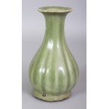 A CHINESE MING STYLE LONGQUAN FLUTED CELADON STONEWARE VASE, the base unglazed, 7.8in high.