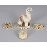 AN EARLY 20TH CENTURY JAPANESE IVORY OKIMONO OF A COCKEREL & HEN, perched on a reed winnowing work