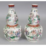 A PAIR OF CHINESE FAMILLE ROSE DOUBLE GOURD PORCELAIN VASES, each painted with scenes of