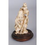 A JAPANESE MEIJI PERIOD IVORY OKIMONO OF FUKUROKUJU, together with a fixed wood stand, the deity