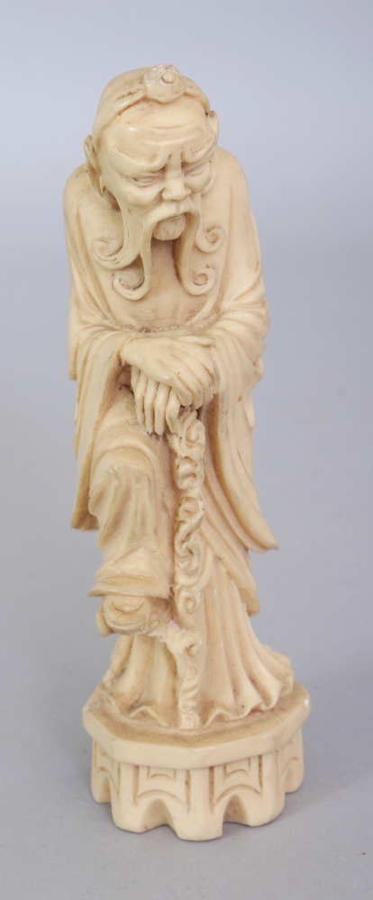 A CHINESE IVORY-STYLE FIGURE OF THE IMMORTAL LI TIEGUAI, leaning forward on his crutch, 5.25in