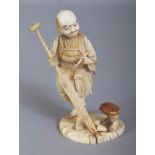 A SIGNED JAPANESE MEIJI PERIOD SECTIONAL IVORY OKIMONO OF A MAN HOLDING AN OAR, the base with an