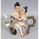 A CHINESE REPUBLIC STYLE FAMILLE ROSE EROTIC PORCELAIN TEAPOT, surmounted by an amorous couple,