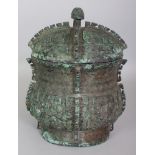 A CHINESE SHANG STYLE BRONZE VASE & COVER, the sides of the oval-section body cast in relief with