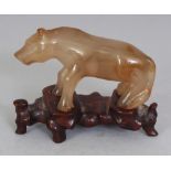 A 20TH CENTURY CHINESE AGATE MODEL OF A STANDING HORSE, together with a fitted wood stand, 2.75in