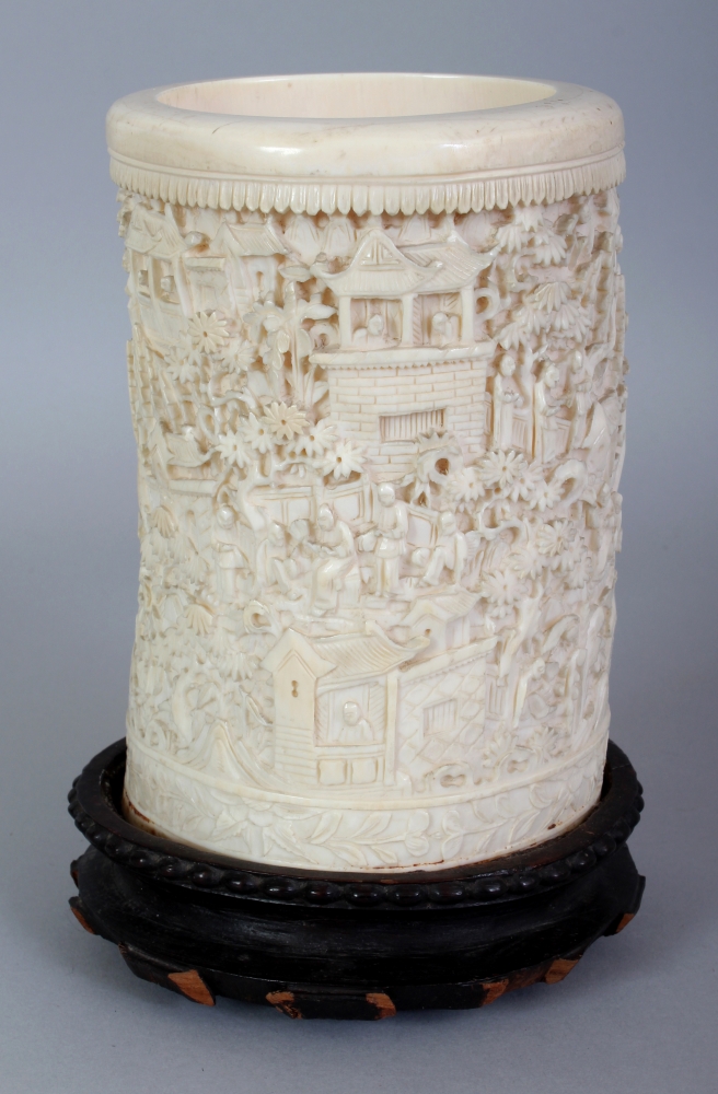 A GOOD LARGE 19TH CENTURY CHINESE CANTON IVORY BRUSHPOT, together with a fixed wood stand, the sides