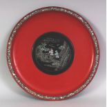 A 20TH CENTURY CHINESE LAC BURGAUTE & RED LACQUER CIRCULAR DISH, decorated to its centre with two