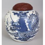 A CHINESE BLUE & WHITE PORCELAIN DRAGON JAR, with a red cinnabar lacquer cover, the cover carved