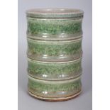 AN UNUSUAL CHINESE BAMBOO FORM PORCELAIN BRUSHPOT, the sides applied with a mottled green glaze, the