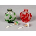 TWO CHINESE OVERLAY GLASS SNUFF BOTTLES & STOPPERS, 3.1in & 2.8in high. (2)