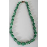 A GREEN HARDSTONE NECKLACE, composed of irregularly shaped beads, approx. 23in long.