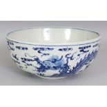 A CHINESE BLUE & WHITE PORCELAIN DRAGON BOWL, the base unglazed, 9.9in diameter & 4.4in high.