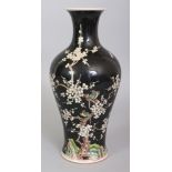 A CHINESE FAMILLE NOIRE BALUSTER PORCELAIN VASE, decorated with birds, plum blossom and rockwork,