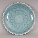 A CHINESE PORCELAIN LOTUS DISH, applied with a bluish celadon glaze, the base with a Qianlong seal