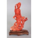 A 20TH CENTURY CHINESE CORAL CARVING OF A LADY, together with a fixed wood stand, the lady
