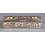 A SOUTH-EAST ASIAN SILVER-METAL RECTANGULAR PILL BOX, weighing approx. 29gm, the cover embossed with