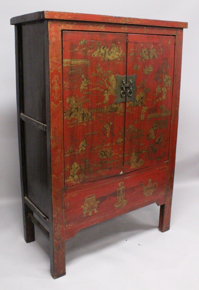 A LARGE EARLY 20TH CENTURY CHINESE RED GROUND LACQUERED WOOD CABINET, with two hinged front doors