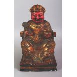 A CHINESE LACQUERED WOOD FIGURE OF A SEATED EMPEROR, with gilt and red lacquer, and with some