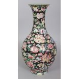 A CHINESE BLACK GROUND MILLEFLEUR FLUTED PORCELAIN VASE, decorated with a profusion of flowers and