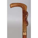 A HORN HANDLED WOOD WALKING STICK, the handle possibly rhinoceros horn and inlaid with mother-of-