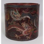 A LARGE CHINESE LACQUER BRUSHPOT, the sides decorated with confronting dragons amidst flame and