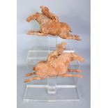A RARE PAIR OF CHINESE TANG DYNASTY RED POTTERY MODELS OF FEMALE POLO PLAYERS, with fitted perspex