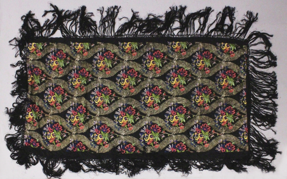 ANOTHER EARLY 20TH CENTURY CHINESE CANTON EMBROIDERED BLACK GROUND SILK SHAWL, decorated in satin