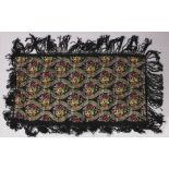 ANOTHER EARLY 20TH CENTURY CHINESE CANTON EMBROIDERED BLACK GROUND SILK SHAWL, decorated in satin
