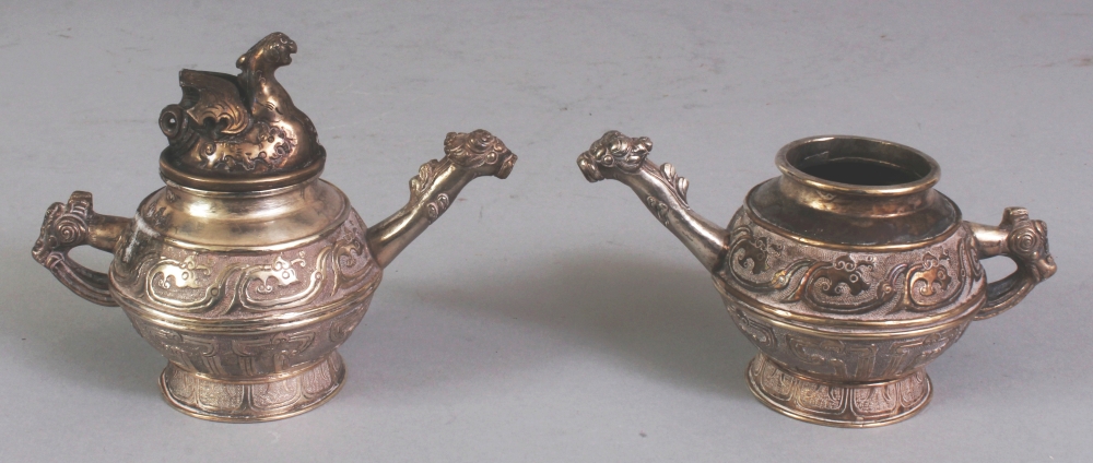 A PAIR OF CHINESE ARCHAIC STYLE MINIATURE SILVER-METAL EWERS, weighing approx. 163gm in total, one