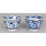 A PAIR OF 19TH CENTURY CHINESE KANGXI STYLE BLUE & WHITE FLUTED PORCELAIN TEABOWLS, with floral