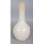 A CHINESE WHITE GLAZED CERAMIC VASE, the sides faintly incised underneath the glaze with bamboo