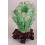 A CHINESE GREEN BOWENITE VASE, together with a fitted wood stand, the vase carved in the form of a