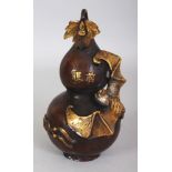 A CHINESE GILT BRONZE DOUBLE GOURD VASE, the sides cast in relief with a bat and a string of 'cash',