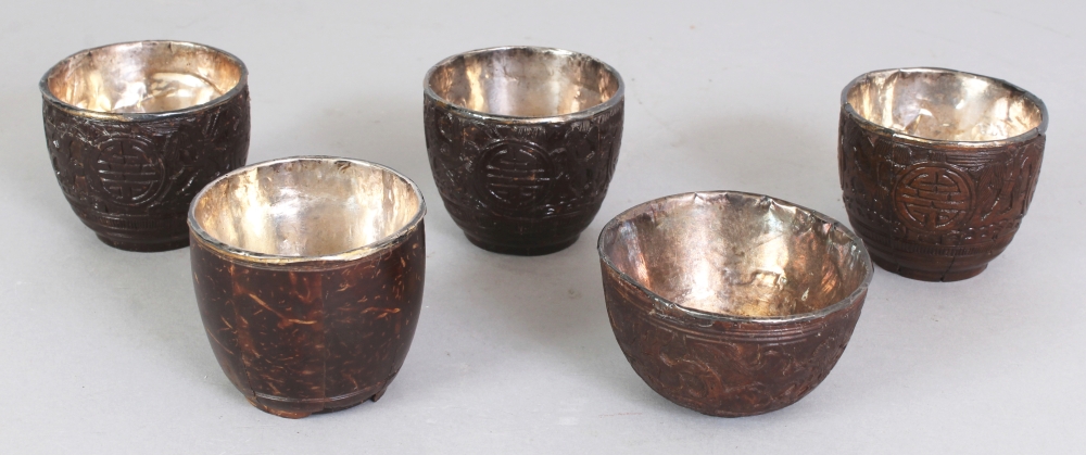 A GROUP OF FIVE 19TH CENTURY CHINESE COCONUT CUPS, with fitted silver liners some bearing an