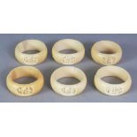A GROUP OF SIX EARLY 20TH CENTURY CHINESE CANTON IVORY NAPKIN RINGS, each carved with figural