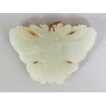 A CHINESE CELADON JADE BUTTERFLY PENDANT, with a gold clasp marked '14K' & '585', 2.25in wide & 1.