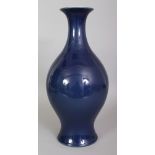 A CHINESE BLUE GLAZED PORCELAIN VASE, of near baluster form and applied with a lustrous glaze, the