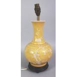 A 20TH CENTURY CHINESE WHITE SLIP DECORATED YELLOW GROUND PORCELAIN VASE, fitted for electricity,