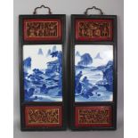 A PAIR OF CHINESE WOOD FRAMED BLUE & WHITE PORCELAIN HANGING PLAQUES, each plaque decorated with a