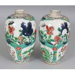 A PAIR OF KANGXI STYLE FAMILLE VERTE PORCELAIN JARS, decorated with panels of foliage, each short